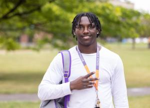 A male student wearing a Buffalo State lanyard