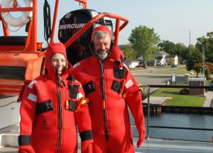  2/20 Katie Hastings and Sasha Karatayev don red survival suits as part of safety training