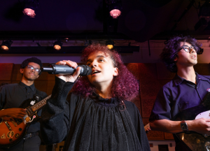 Three students performing music