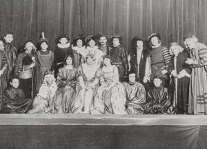Black and white photo of a group of actors on stage in Shakespearean costumes 