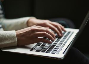 Hands typing on a keyboard