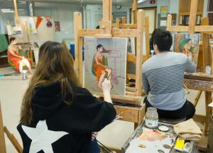 Lin Jiang's painting class in front of their easels.