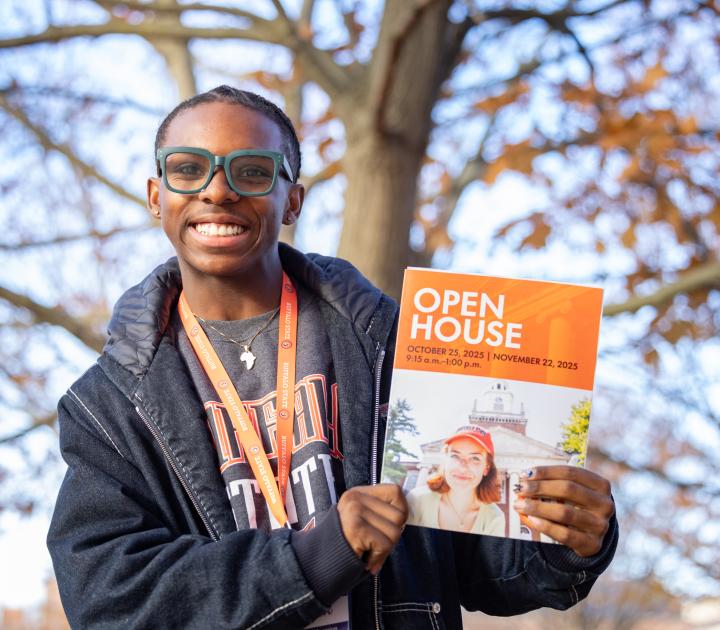 Male student holding an open house brochure